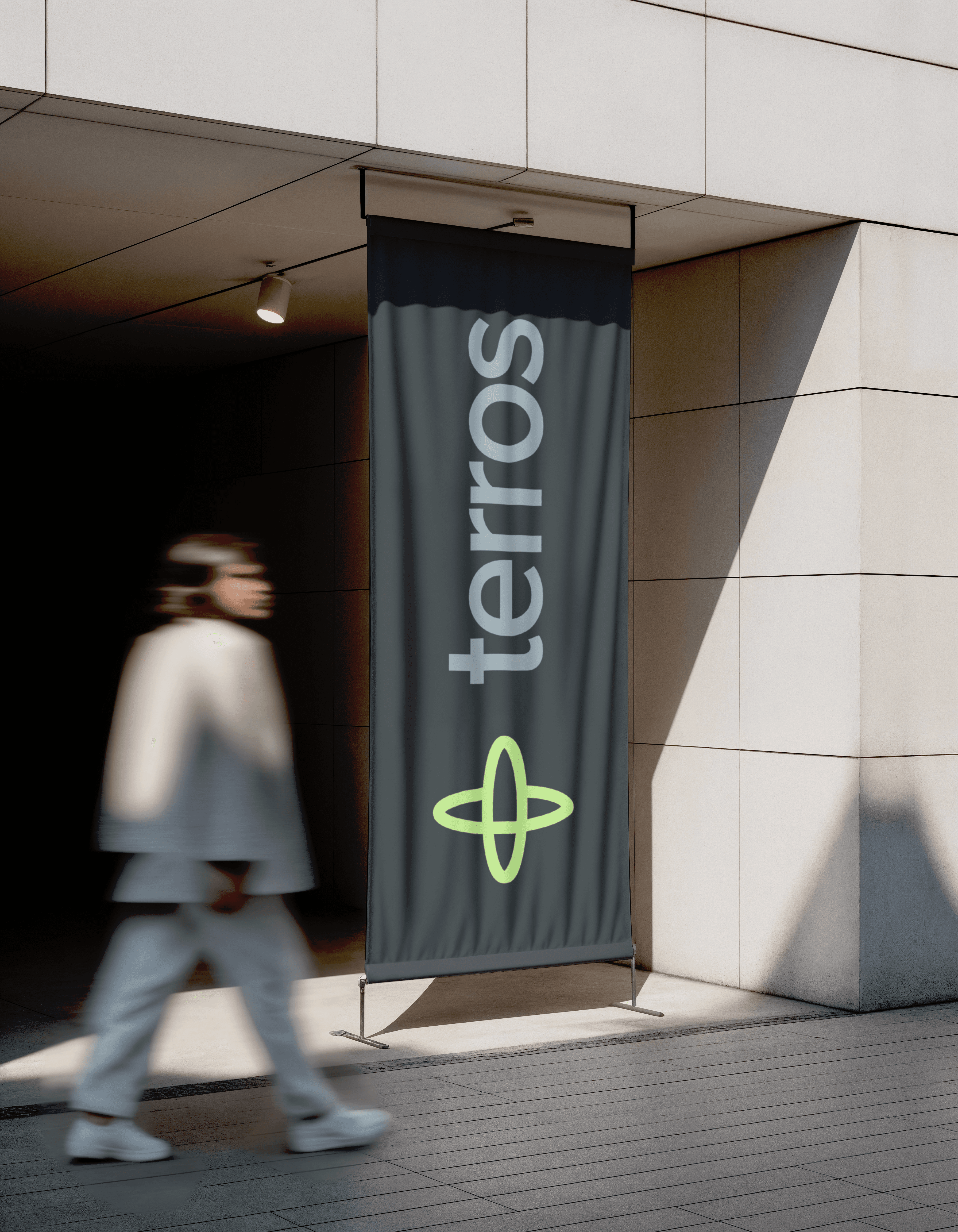 A Terros banner at a building entrance, with someone walking past